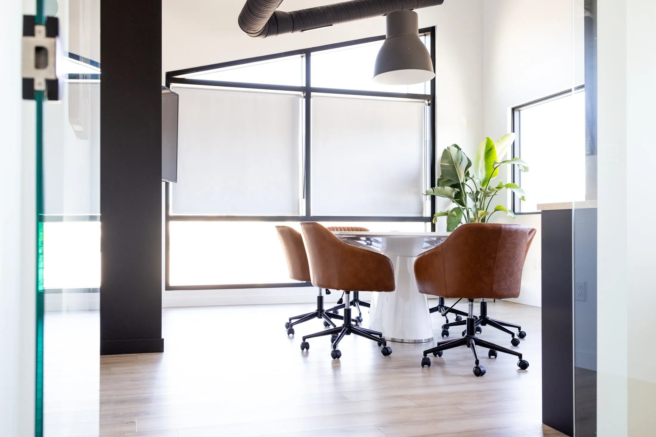The boardroom under its slanted ceiling, the angled black window frame catching the light